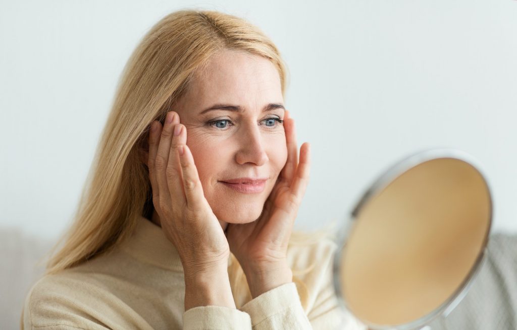 Perfect skin. Middle-aged woman satisfied with her skin