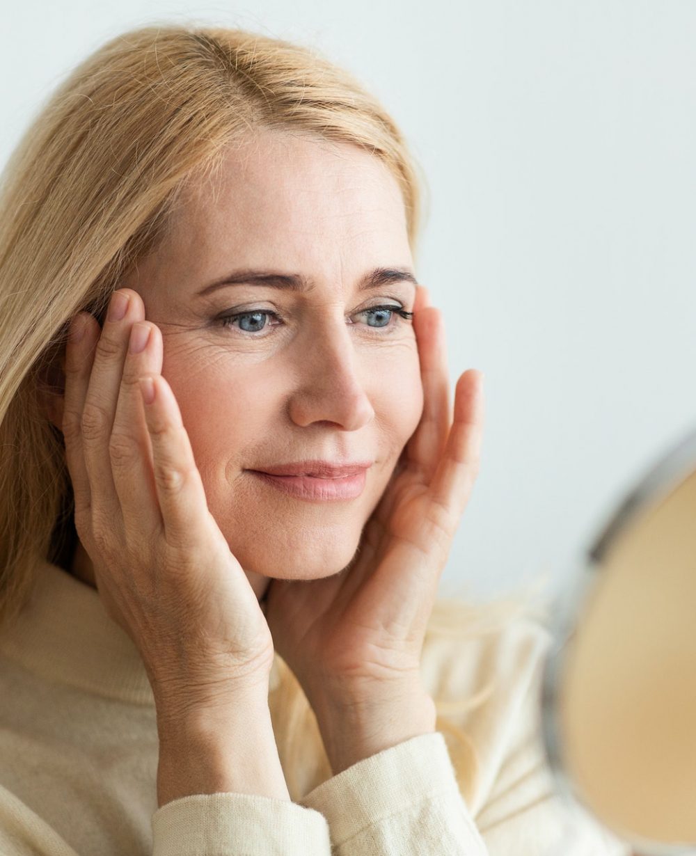 Perfect skin. Middle-aged woman satisfied with her skin